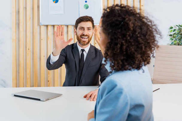 Successful business team giving high five in the office - Photo, Image
