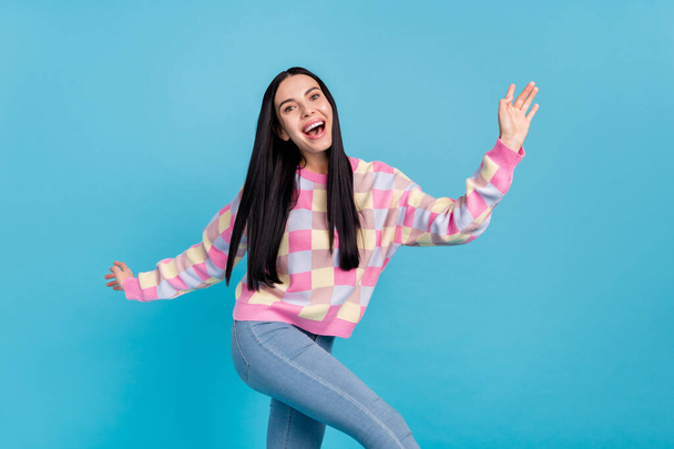 Photo of shiny excited young woman wear pink sweater dancing smiling isolated blue color background - Foto, Imagen
