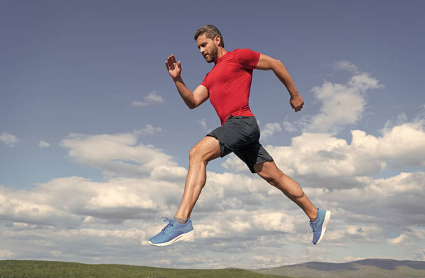 sportsman man runner run to success or jump high on sky background, sport - Photo, Image