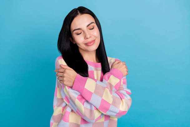 Photo of dreamy charming lady dressed print pullover hugging herself isolated blue color background - Foto, immagini