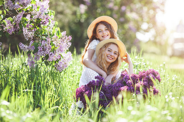 Cute girls outdoors. Pretty sisters together. Cheerful girls. - Zdjęcie, obraz