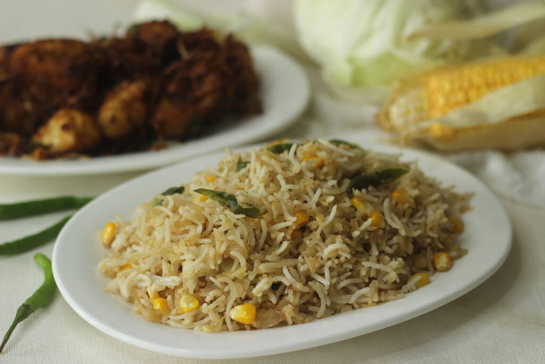 Cabbage corn fried rice. A tasty rice dish with sauteed cabbage and corn flavoured with garlic. A quick meal option served with chicken roast prepared in kerala style. Shot with fresh cabbage and corn - Photo, Image