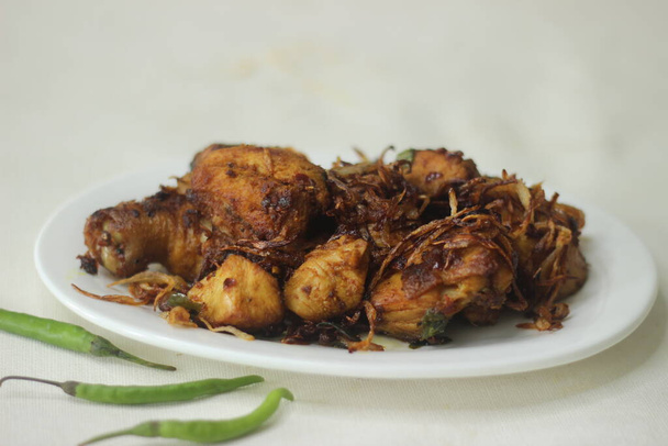 Chicken roast. Chicken prepared in Kerala style with onions tomatos and spices. - Photo, Image