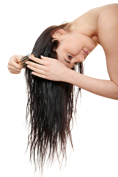 Beautiful young woman brushing hairs - Фото, изображение
