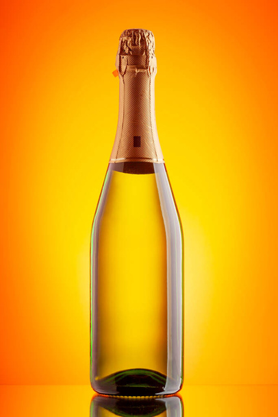 Champagne sparkling wine bottle. Over yellow background - Zdjęcie, obraz