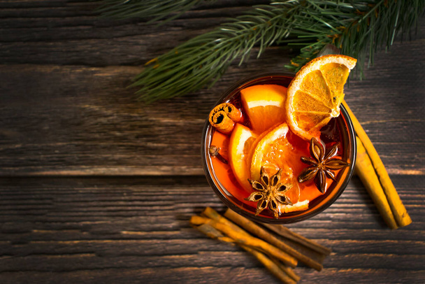 mulled wine in a glass cup on a wooden background - Photo, Image