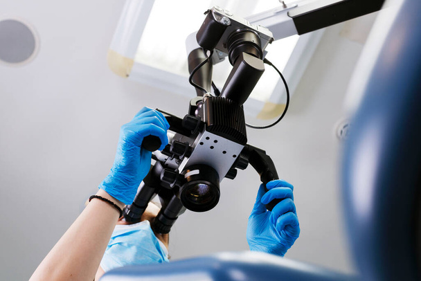 Dentist and modern microscope for complex tooth treatment - Photo, image