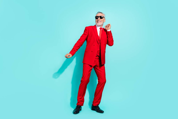 Photo of pretty retired man wear red three piece suit dark eyewear dancing isolated turquoise color background - Foto, Imagen