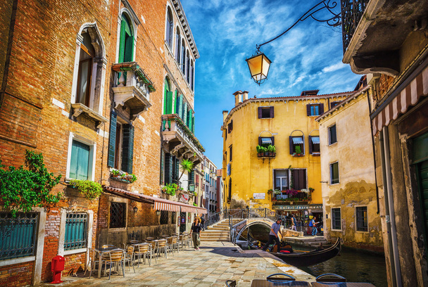 Narrow canal among old colorful brick houses in Venice - Photo, image