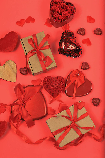 Concept for Valentine's Day or Women's Day, Mother's Day, banner. Greeting card, hearts and gift boxes on a red background, congratulations on the holiday, birthday, selective focus - Foto, afbeelding