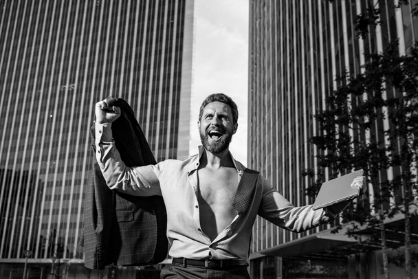 Excited business man model in unbuttoned shirt outdoor. - Photo, Image