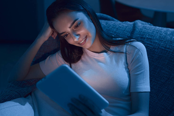 Woman reading e book in evening - Zdjęcie, obraz