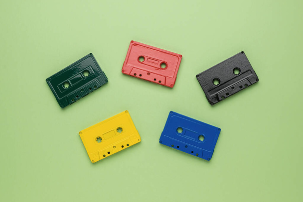 Five multi-colored tape cassettes on a light green background. Vintage style in sound recording. Flat lay. - Valokuva, kuva