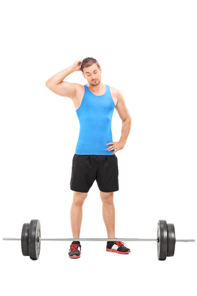 Male athlete looking at barbell - Foto, immagini