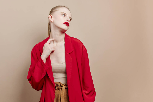 γυναίκα μακιγιάζ σε κόκκινο σακάκι μοντέλο στούντιο αναλλοίωτη - Φωτογραφία, εικόνα