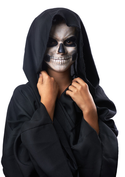Teen with make-up of skull in black cloak laughs - Fotoğraf, Görsel
