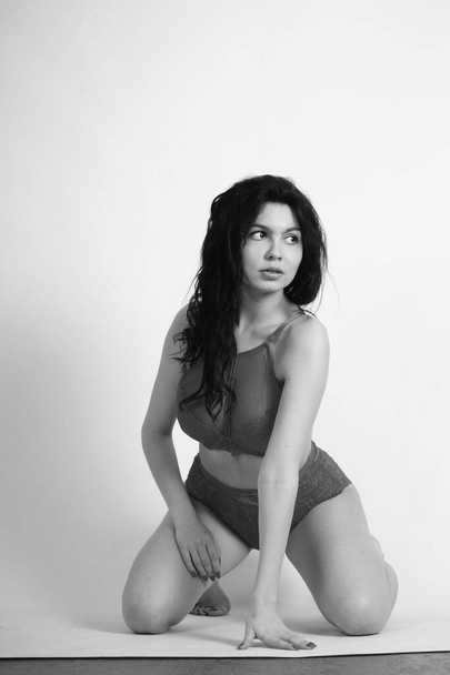 beautiful young woman in lingerie posing in studio - Fotó, kép