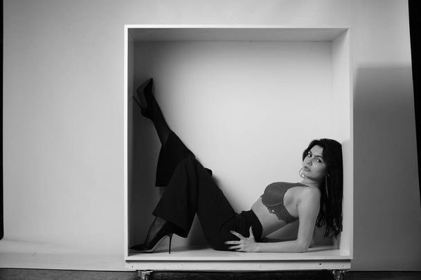portrait noir et blanc de belle femme sexy en vêtements noirs posant en studio - Photo, image