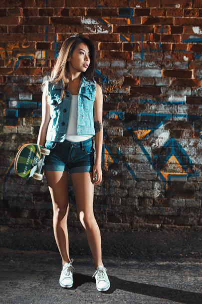 teen girl with skate board. Outdoors, urban lifestyle. - Fotó, kép