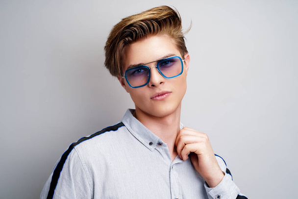 Hipster young guy in stylish eyewear while looking at camera. Stylish hairstyle. Fashion man - Fotoğraf, Görsel