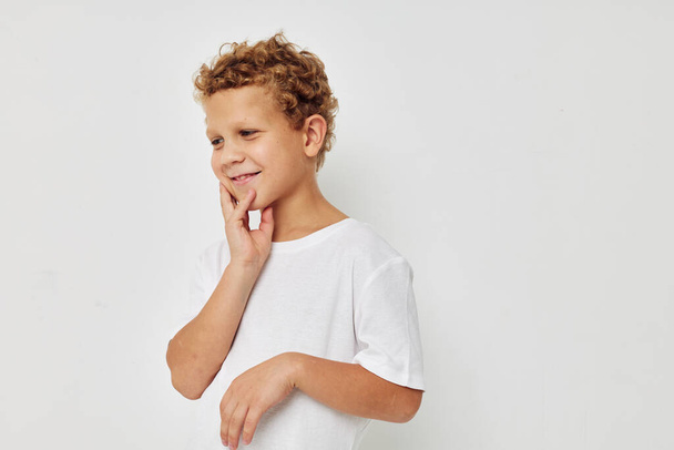 curly boy in a white t-shirt posing fun childhood unaltered - Photo, Image