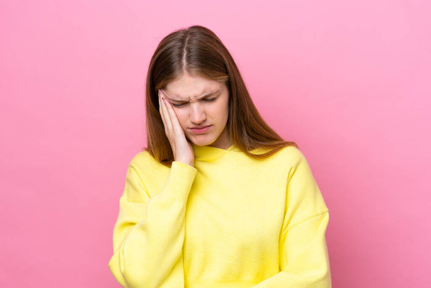 Teenager Russian girl isolated on pink background with headache - Photo, Image
