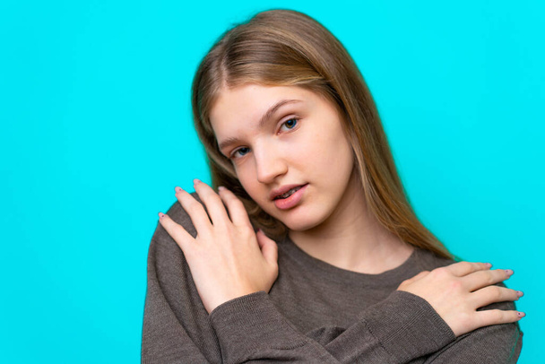 Teenager Russian girl isolated on blue background - Фото, изображение