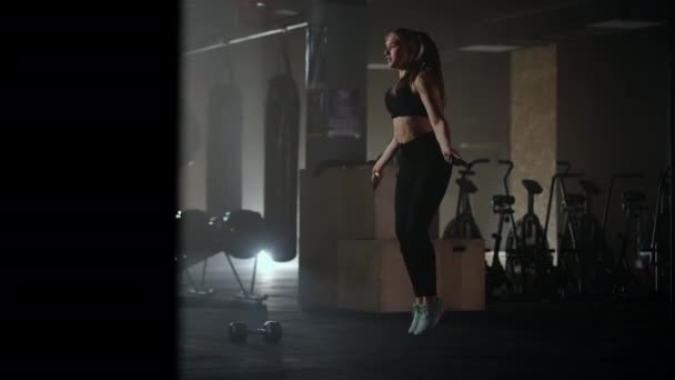 Skipping woman training at the gym working out is healthy fitness body. Young woman skipping rope. Woman trains and jumping rope, coordination training - Footage, Video