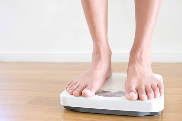 Legs of men standing on scales weight. Concept of health and weight loss. - Photo, Image