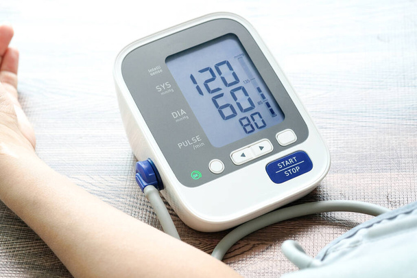 Kan basıncı monitörünü ve kalp atış hızı monitörünü dijital basınç göstergesiyle kontrol edin. Sağlık ve Tıp Konsepti - Fotoğraf, Görsel