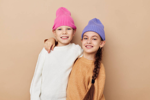 two funny little girls in colorful hats posing - Foto, immagini