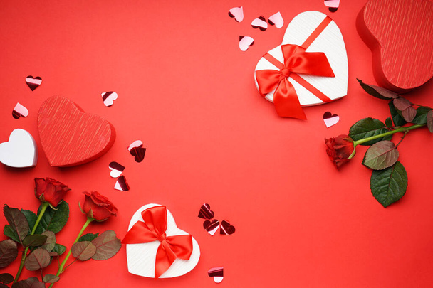 Gift box for Valentine's Day and roses on red background with space for text, top view. - Foto, immagini