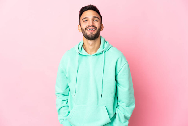 Young caucasian man isolated on pink background laughing - Foto, immagini