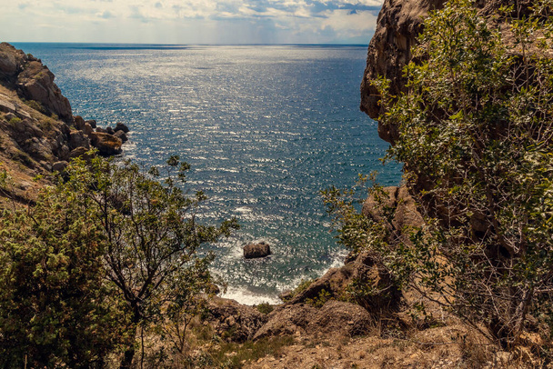 Seascape from the top of the mountains. The nature of the sea. Clouds, sea, mountains. A sunny day. Horizontal photo. Vacation, travel. Concept: calendar, cover. - Fotó, kép