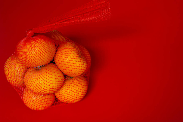 Concept image of the chinese new year. Mandarin orange on red background - Фото, зображення