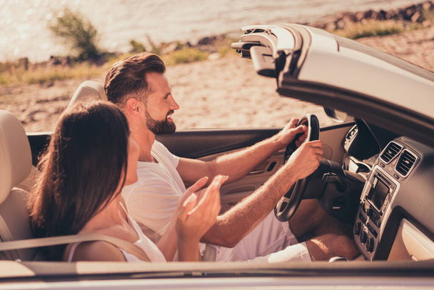 Photo of pretty sweet married couple dressed white clothes driving car talking smiling outdoors country side road - Фото, зображення