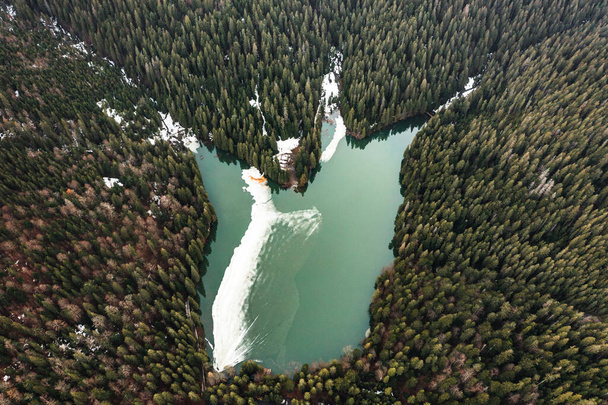 Lake Synevyr in the Carpathians of Ukraine, the lake was taken from a drone, the view of the lake from above, early spring in the Carpathians. - Photo, Image