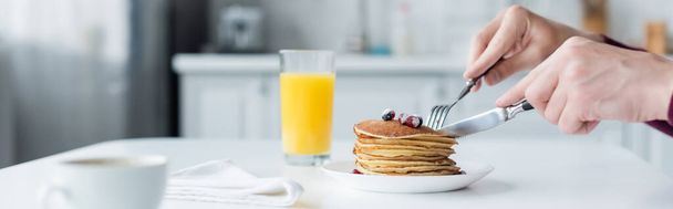 partial view of man cutting pancakes near orange juice and coffee cup, banner - Fotoğraf, Görsel