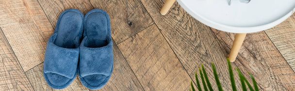 top view of blue slippers on wooden floor in bedroom, banner - Fotoğraf, Görsel