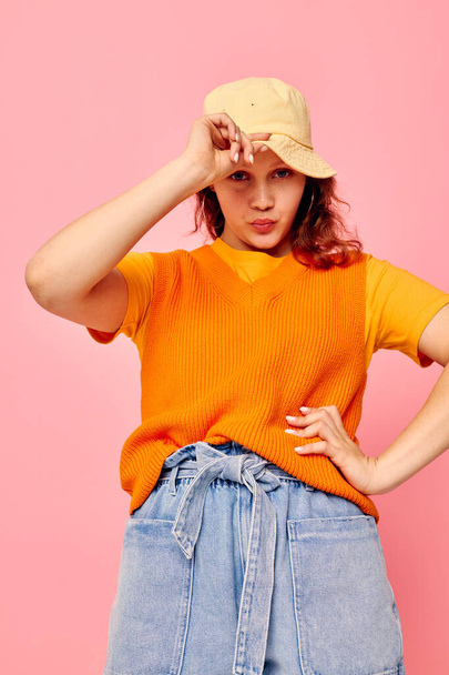 beautiful woman in an orange sweater in yellow hat hand gesture isolated backgrounds unaltered - 写真・画像