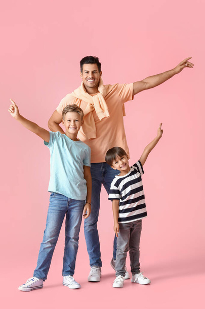 Happy man and his sons on color background - Photo, Image