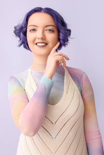 Beautiful young woman with violet hair on color background. Very Peri - color of year 2022 - Photo, Image