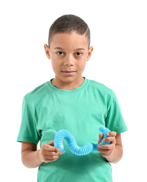 Little African-American boy with blue Pop Tube on white background - Photo, Image