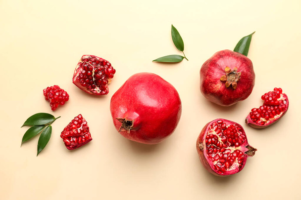 Ripe delicious pomegranate on yellow background - Фото, изображение