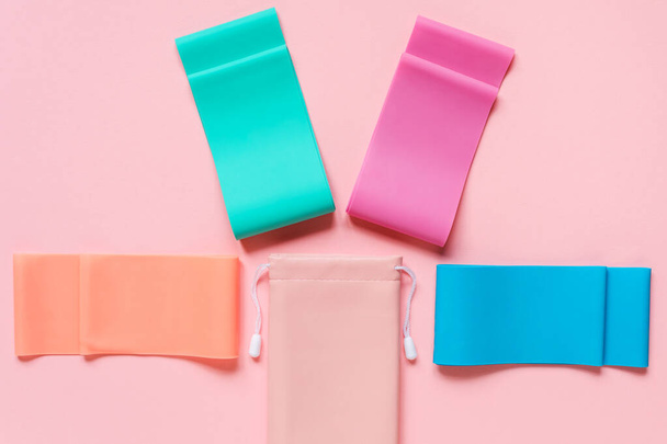 Elastic resistance band and storage pouch on the pink backgground, sport or fitness equipment.  - Foto, Imagem