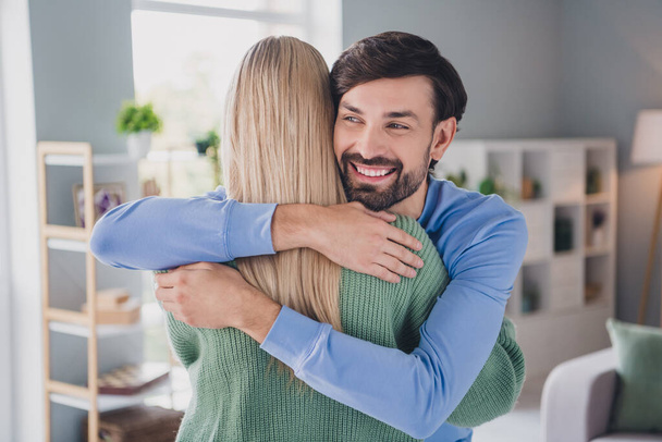 Portrait of two attractive cheerful tender people soulmate hugging congratulating supporting each other at home indoors - Foto, afbeelding