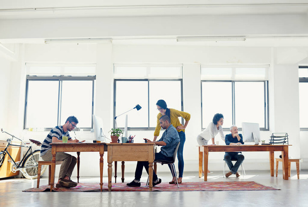 Its a creative environment. Shot of a group of creative professionals working in an office. - Foto, Imagen