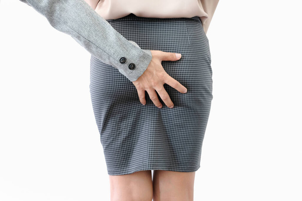 A man's hand catches a woman's an ass and leg of office girl. He is sexually abusing. Woman office wear short skirt be assaulted sexually. Mental Health and Sexual Abuse Concept. - Foto, immagini