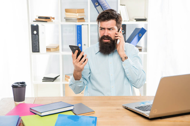 Worried lawyer talking on cellphone using smartphone at office desk, mobility - Foto, Imagen