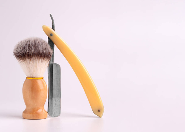 Shaving brush and vintage razor on a white background. - Zdjęcie, obraz